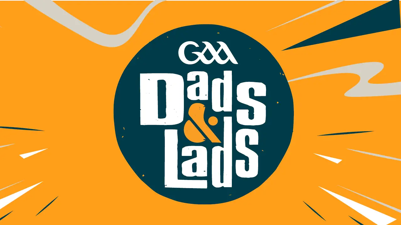 GAA Dads and Lads logo with white text on dark teal circle against bright orange radiating background